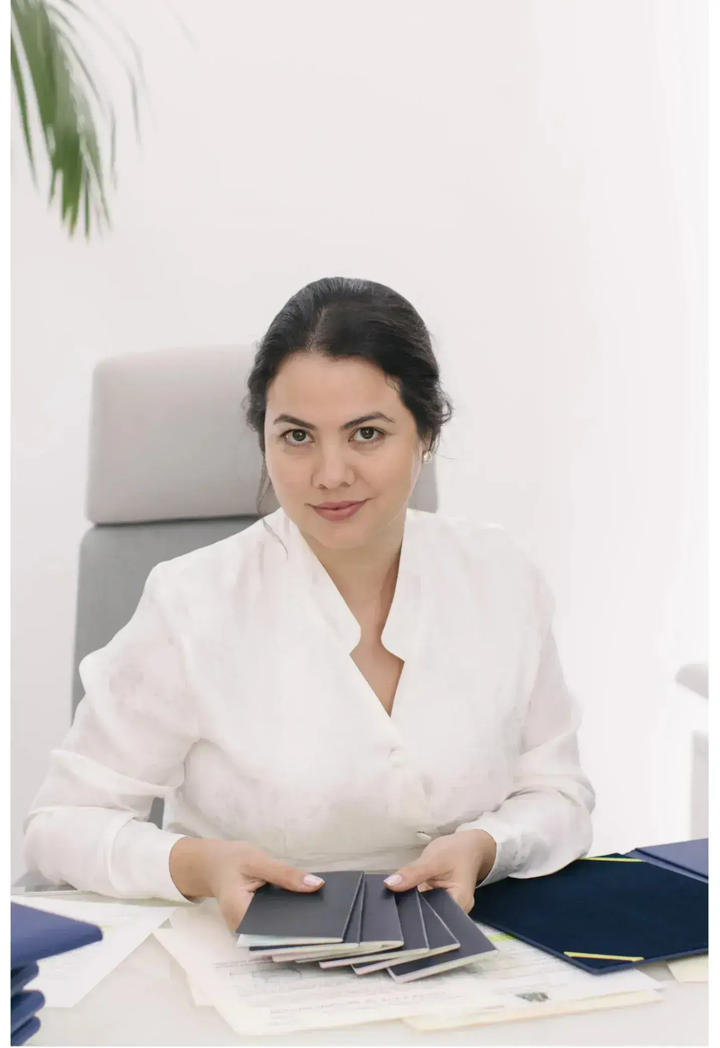 Giselle Bru, Founder of PassPro — portrait alongside the firm's standing.