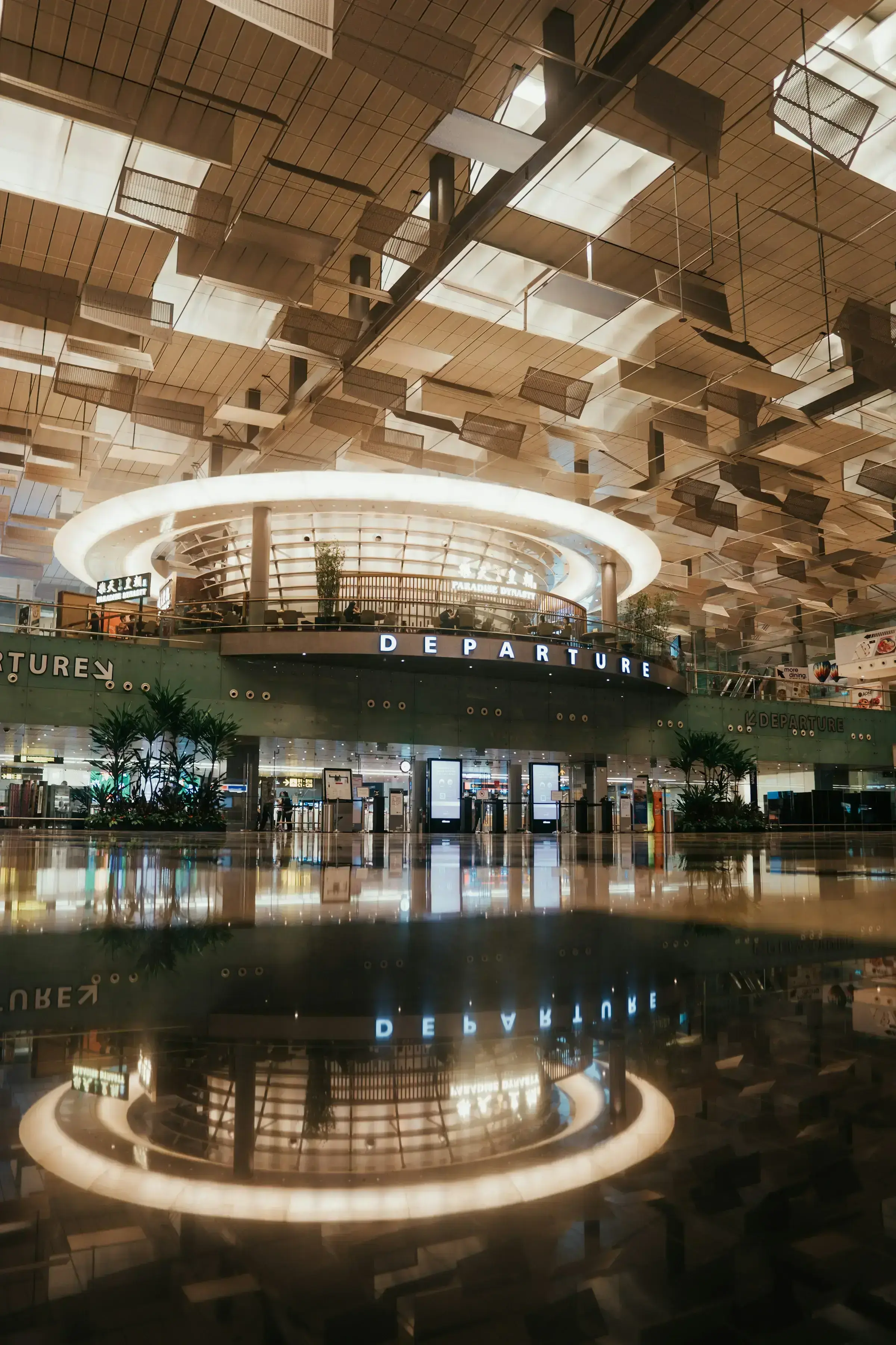 The wide, calm interior of an international airport terminal — premium travel as the practical outcome of stronger mobility.