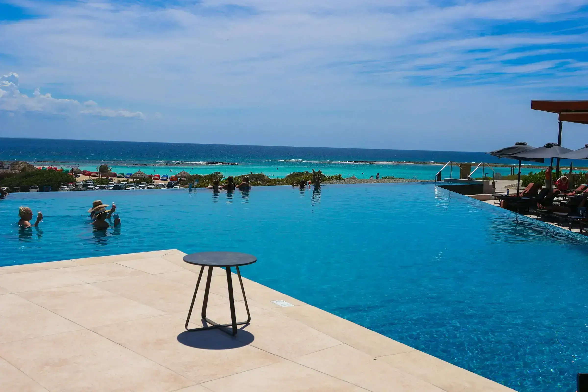 A boutique Caribbean property with a pool and a clear view to the sea.