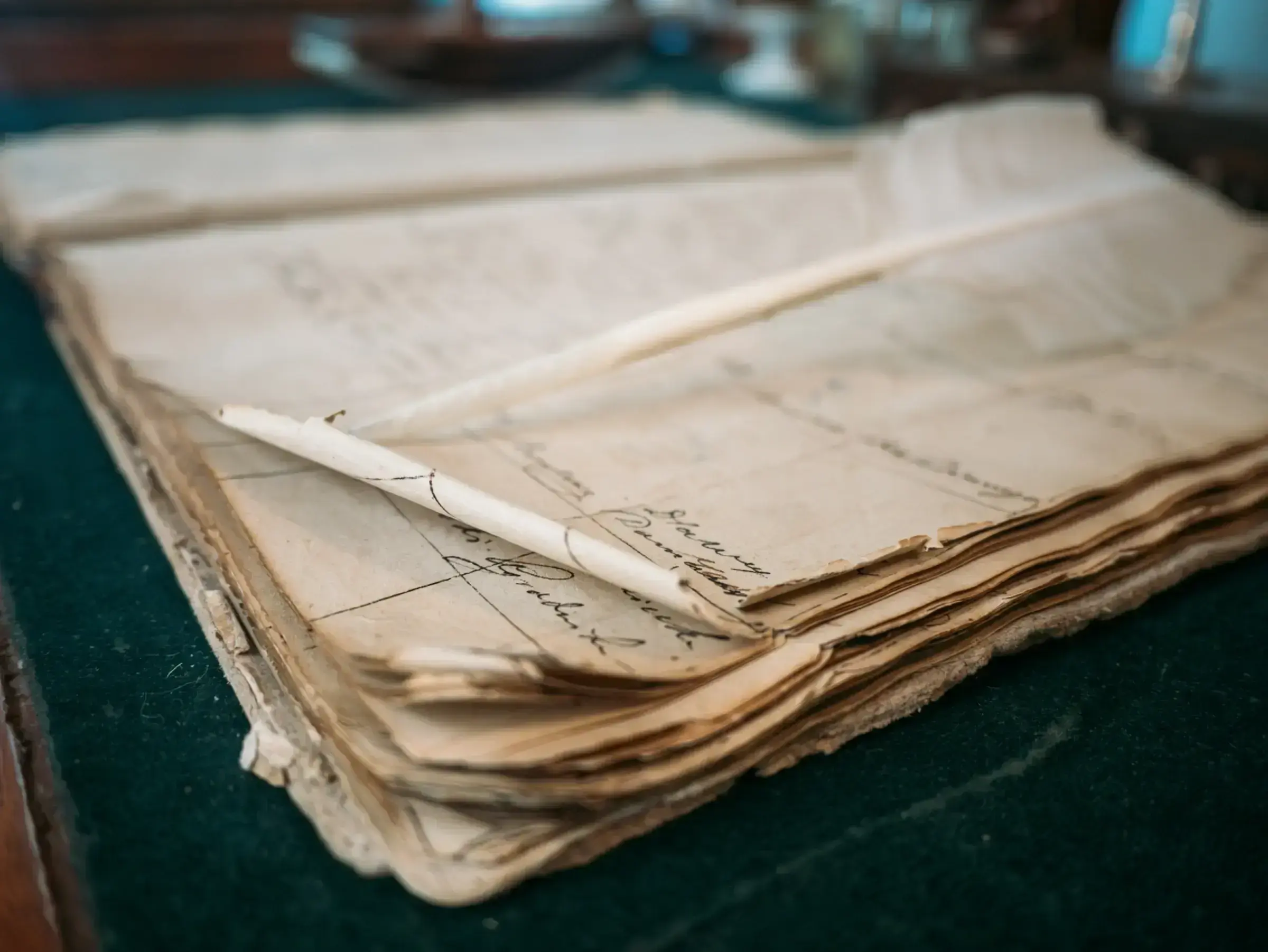 A measured, orderly desk arrangement of financial documents and a pen, suggesting careful financial preparation.