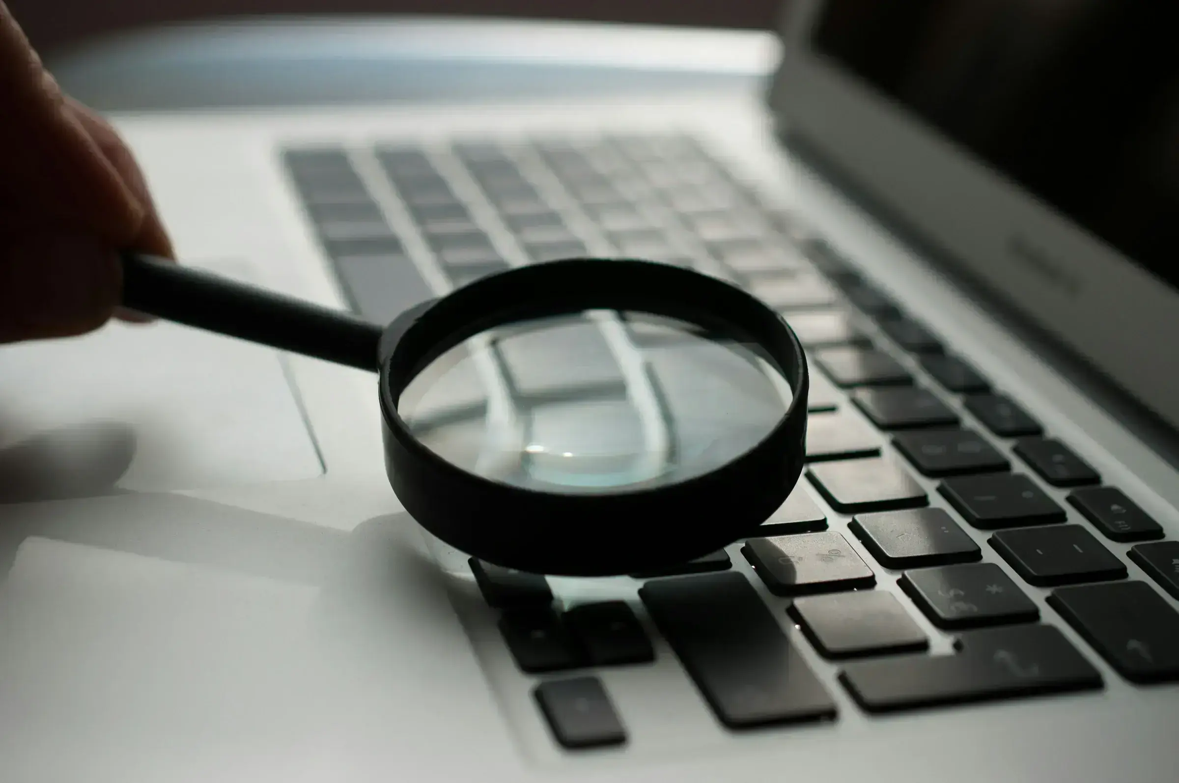 A magnifying glass resting on a document — the scrutiny that defines a serious due diligence review.