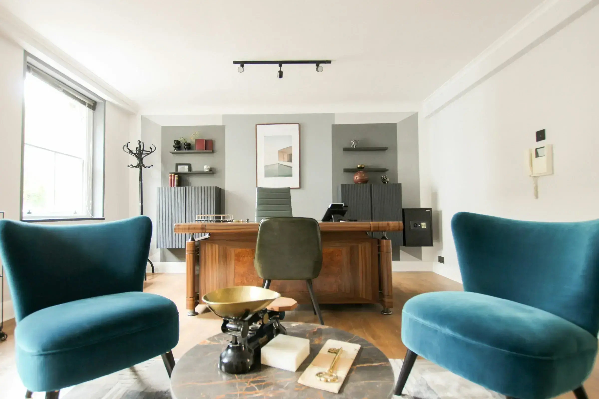 Two chairs facing each other in a discreet senior office — the considered, private nature of a serious advisory conversation.