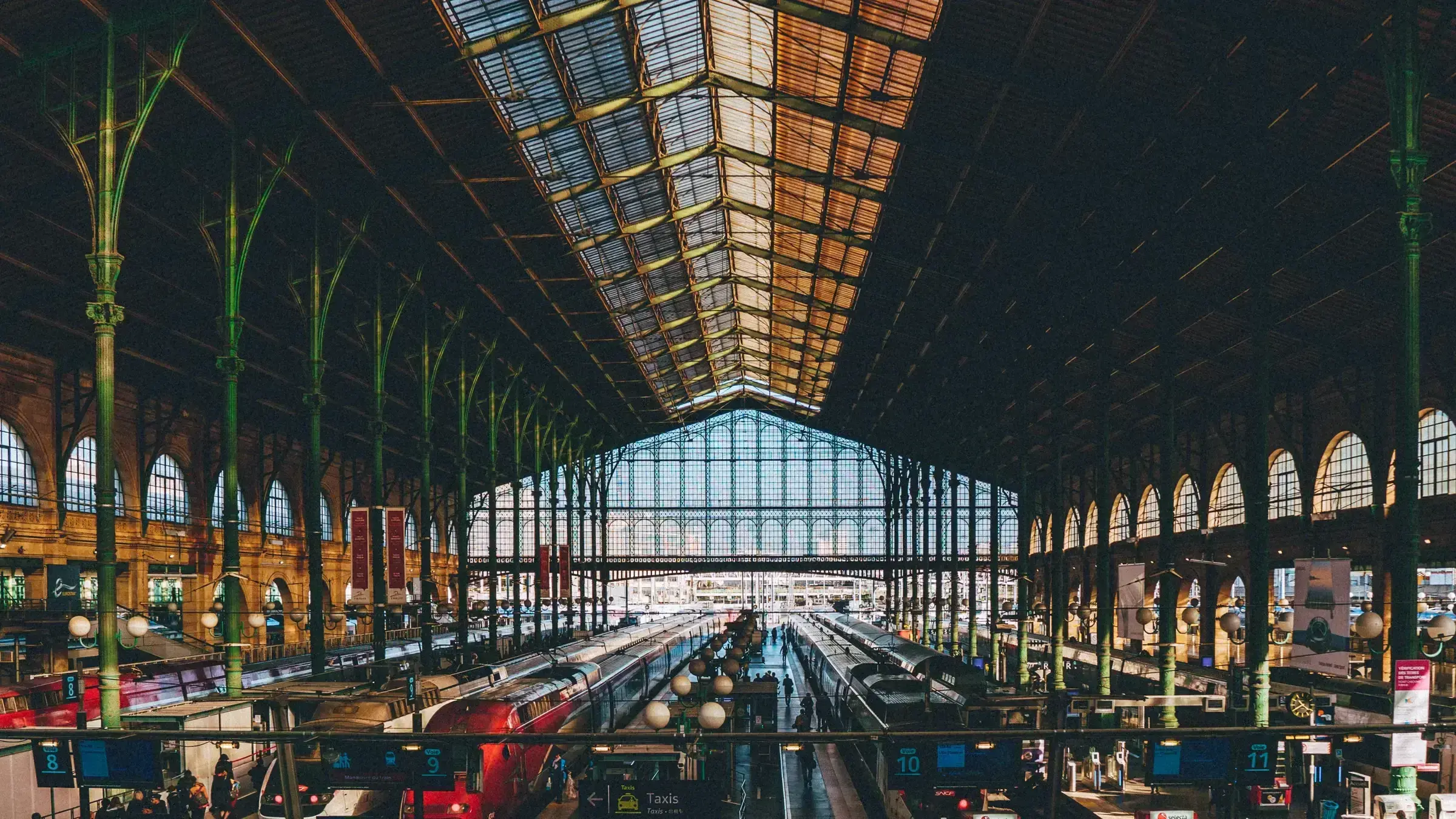 A European airport arrivals concourse, with travellers moving through a busy international gateway.
