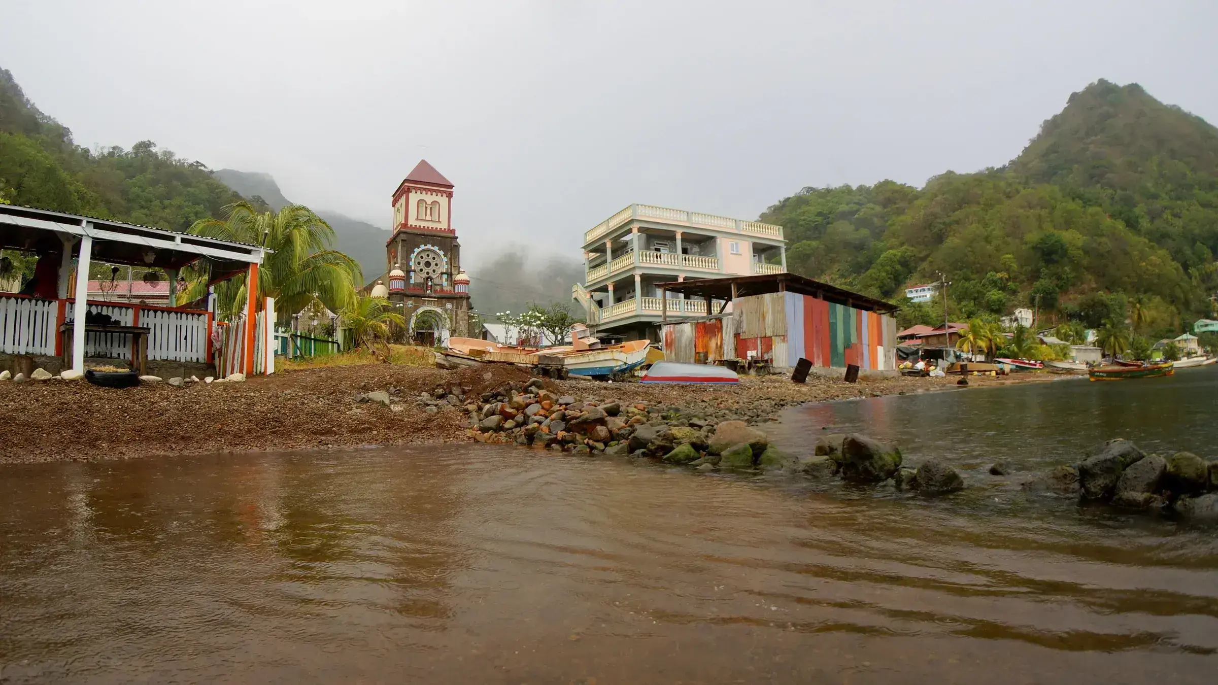 Soufrière village, Dominica — the wooden houses and shoreline used for coastal village scenes in Dead Man's Chest.