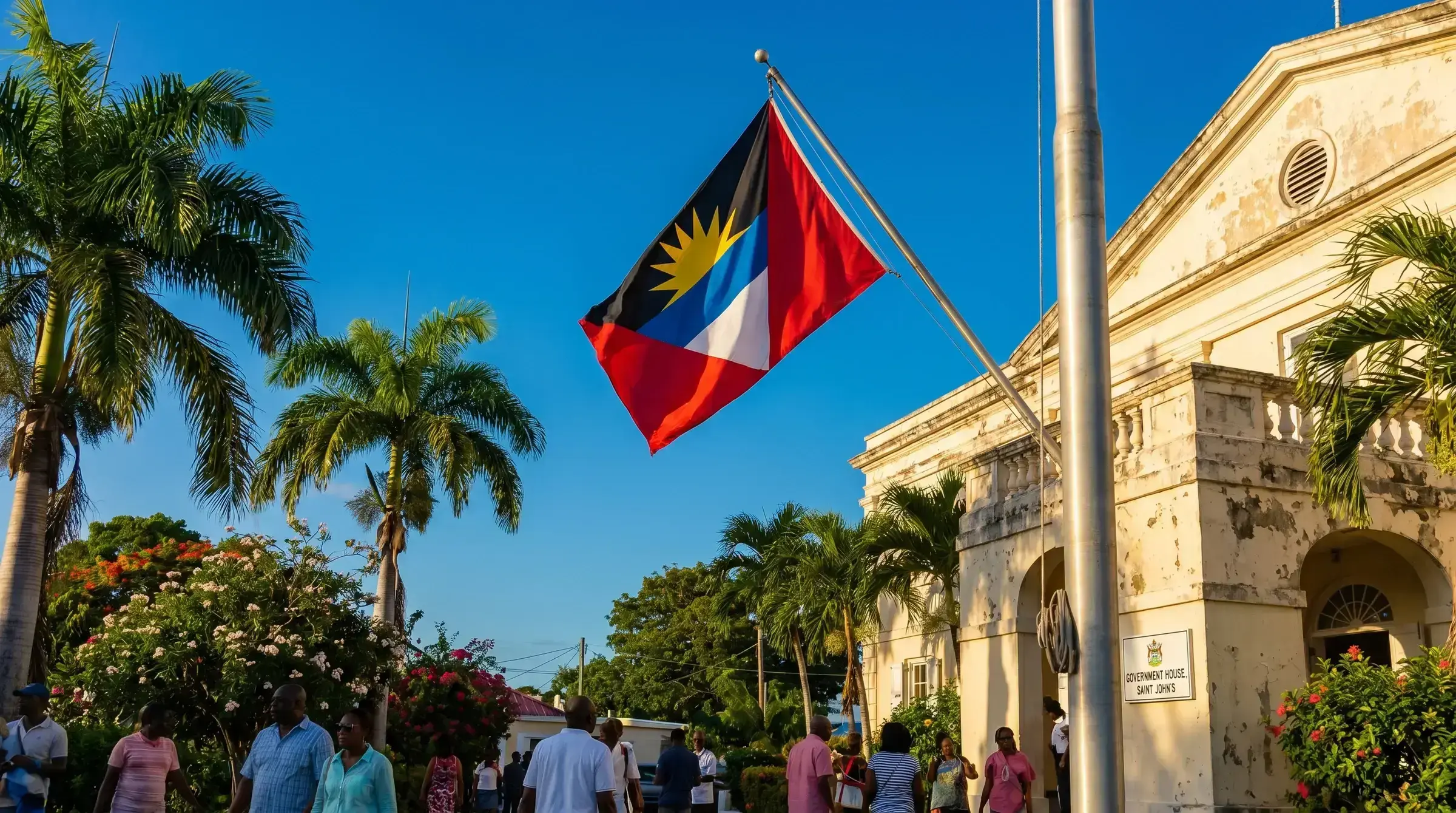 The flag of Antigua and Barbuda flying at a government building.