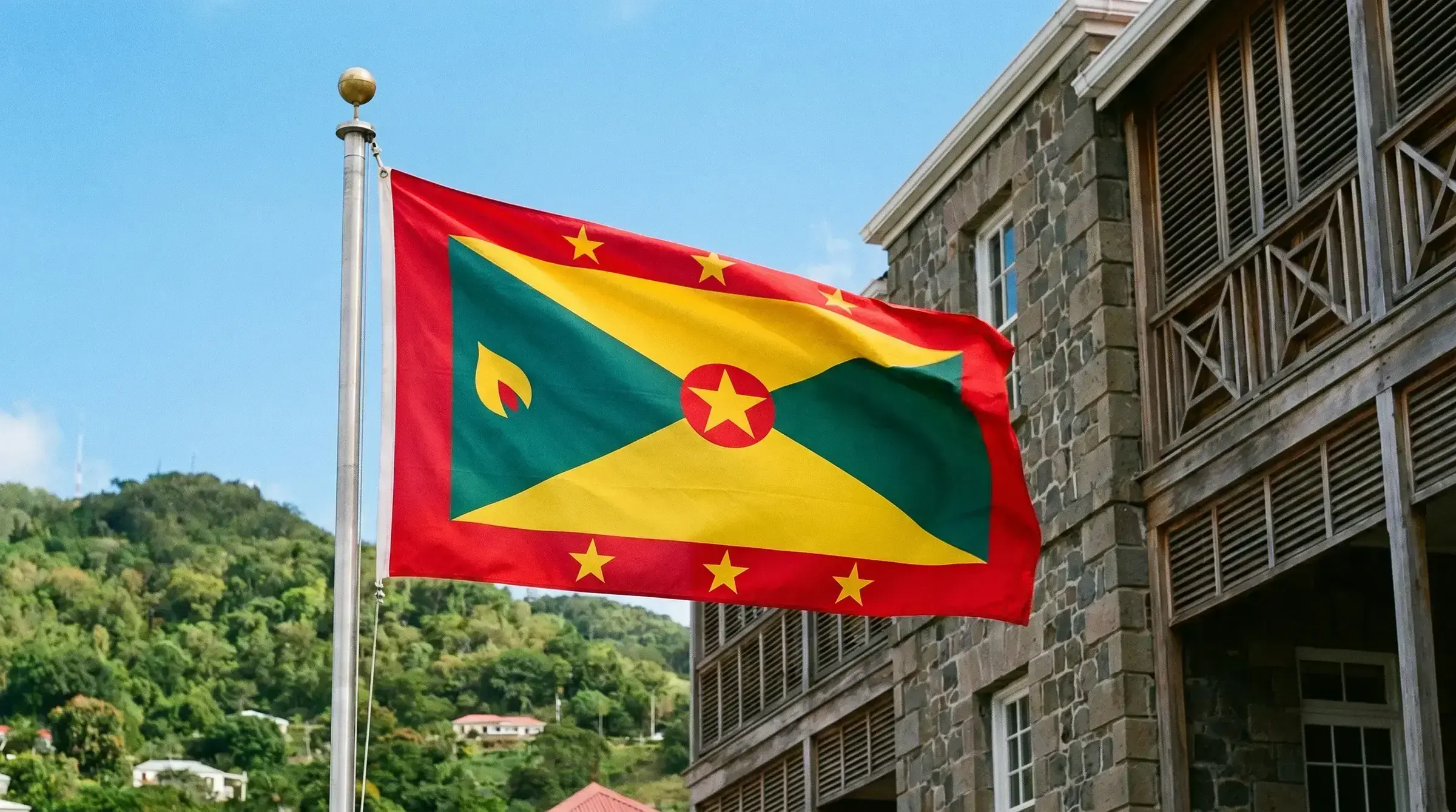 The flag of Grenada flying at a government building.