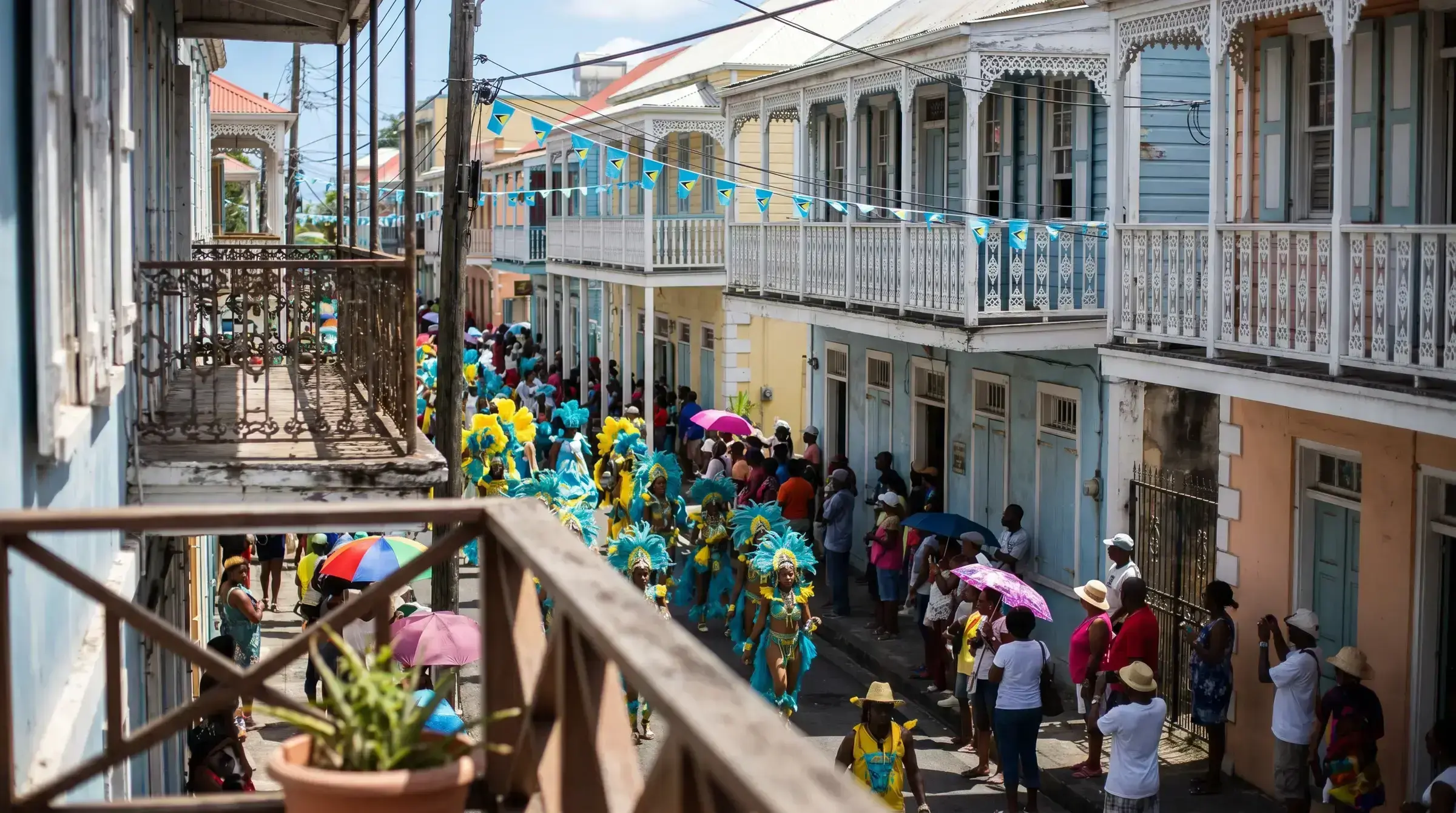 St Lucia Carnival procession winding through the painted balconies of Castries — turquoise costumes and bunting against pastel colonial architecture.