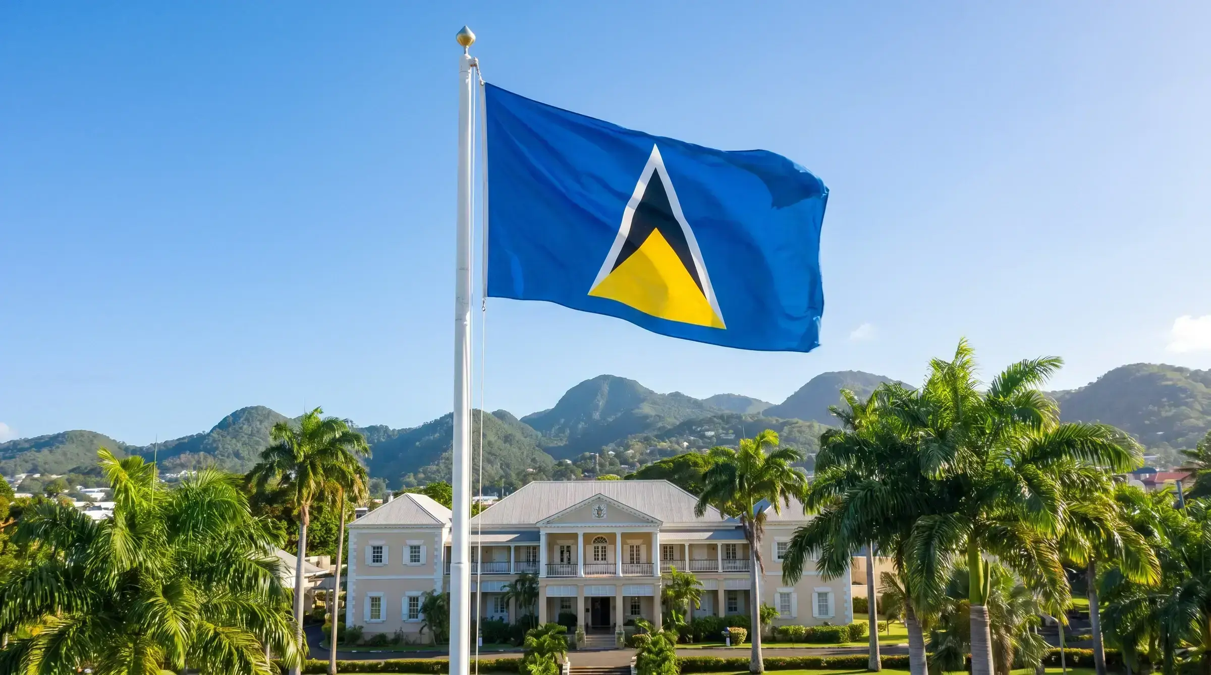 The flag of St Lucia flying at a government building.