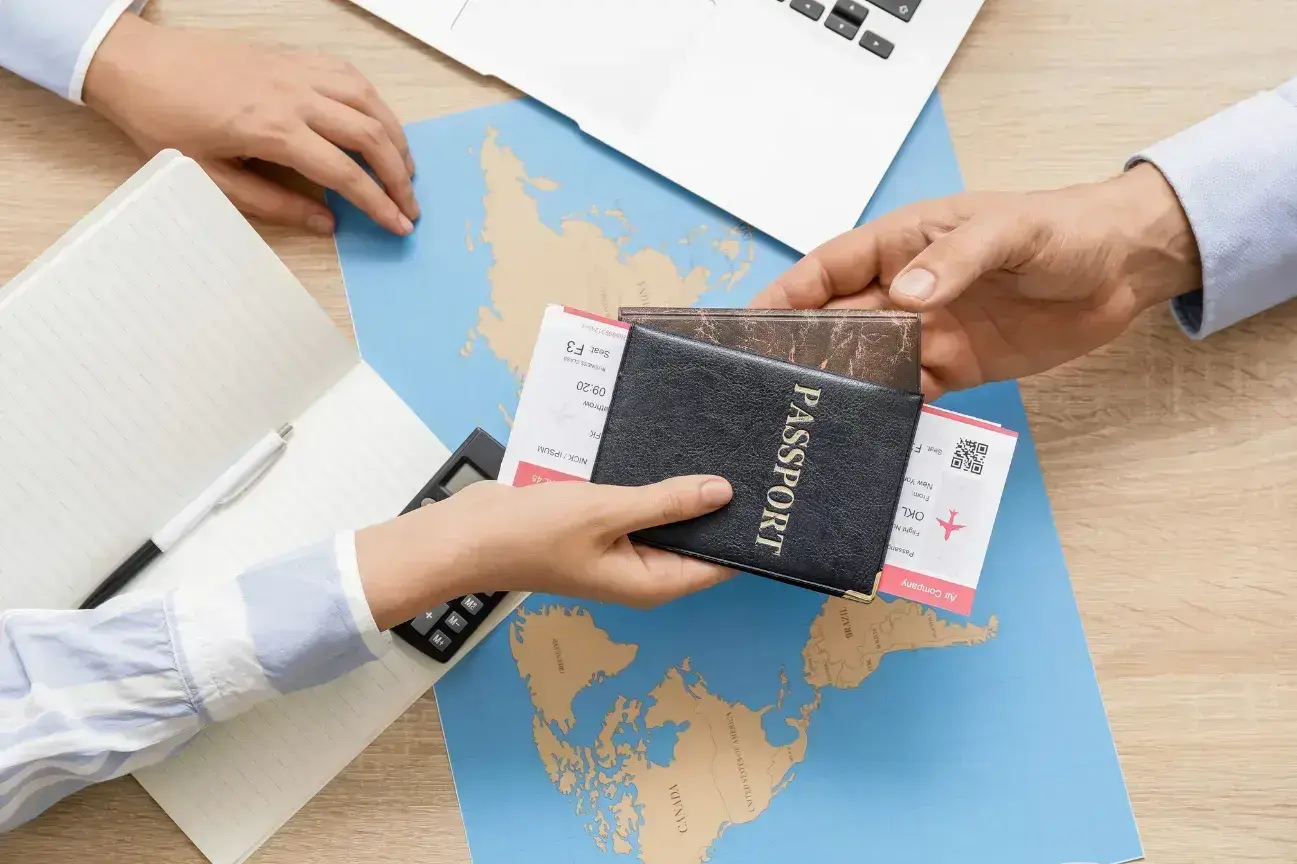 Two hands across a desk — a passport and tickets being handed over, a world map between them. PassPro advisory in practice.
